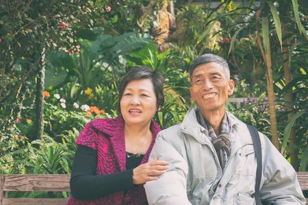 outdoor portrait of happy old couple in park, vintage styleの写真素材