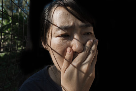 depress woman in cage with light (abuse concept)