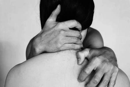 hand of man around neck of woman on white in white toneの写真素材