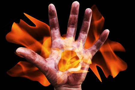 scary hand with blaze on blackの写真素材