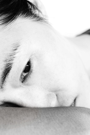 sadness woman leaning on chair in white toneの写真素材