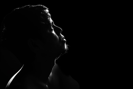 depressed and hopeless man alone in the darkの写真素材