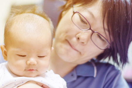 portrait of baby with mother and gradient