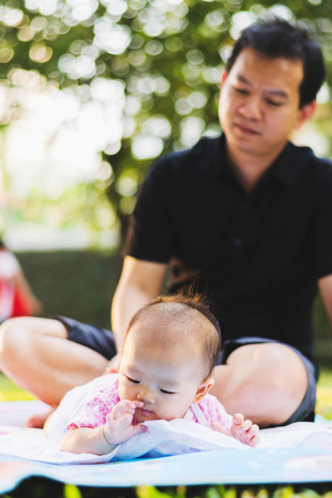 father parenting baby on parkの写真素材