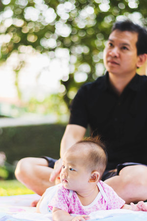 father parenting baby on park