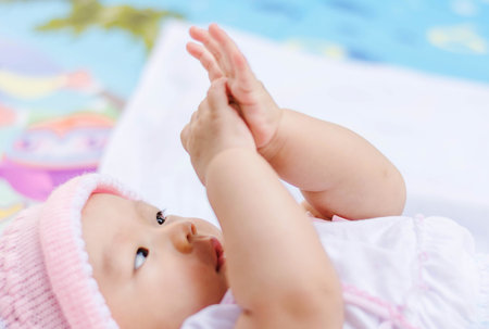 cute Asian baby lie on ground at park