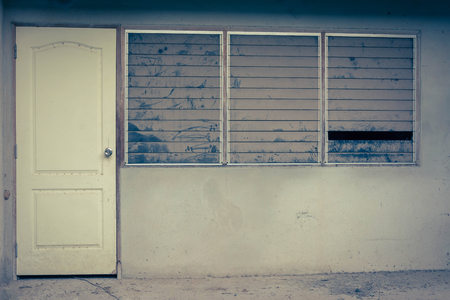 Window and door of abandoned house in villageの写真素材
