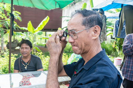 Bangkok Thailand-July 1,17 : Unidentified Thai Buddhism inspects on buddha amulets at amulet market in Chainat,Thailand.のeditorial素材
