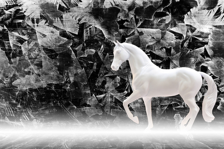 Statuette of white horse isolated on zinc sheet background with mist, fairy tale conceptの写真素材