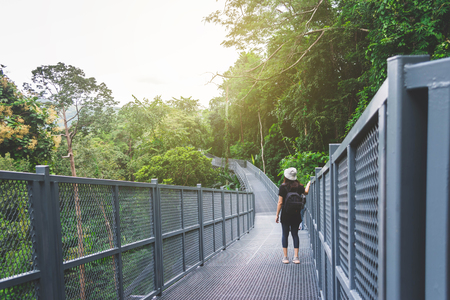View of young woman looking at the view from sky walk at Chiangmai Mountain, Thailand.の写真素材