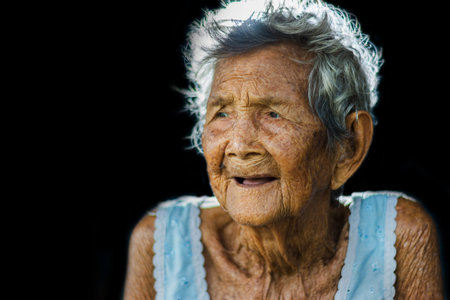 Portrait of  depress and helpless elderly woman, grandma sitting outdoor waiting for children come...