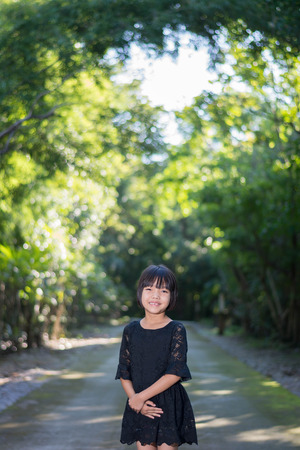Portrait of Happy Asian girl smiling out door in forestの写真素材