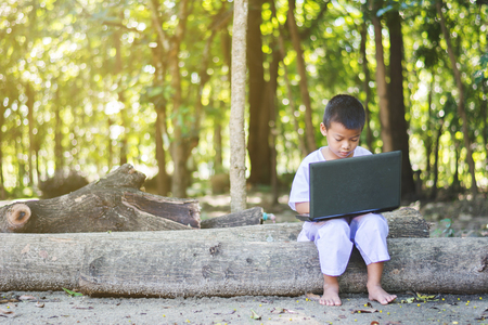 Asian girl using notebook of searching some information at countryside of Thailandの写真素材