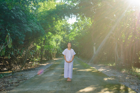 kid on white clothing , practice walking Meditation in forest tree with peace in minの写真素材