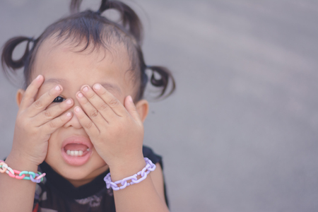 photo of children hand cover face with with crying , retarded, Child Abuseの写真素材