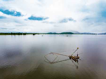 square dip net fishing at lake with mountain and blue sky background at countryside of Thailandの写真素材