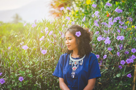 woman enjoy moment with flower in field at forestの写真素材