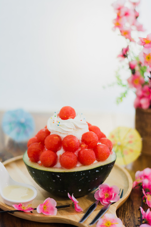 Closeup water melon Bingsu on tray, Bingsu or Bingsoo, Korean shaved ice dessert with sweet toppings and fruit and varieties with ingredients,  popular dessert.の写真素材