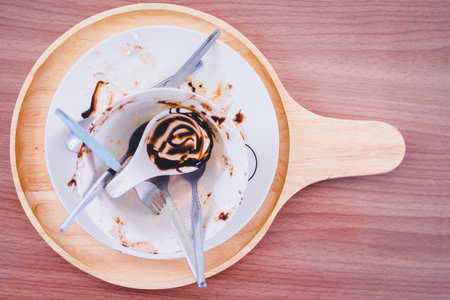empty disk after finish eating chocolate Bingsu, Korean shaved ice dessert with sweet toppings and fruit and varieties with ingredientsの写真素材
