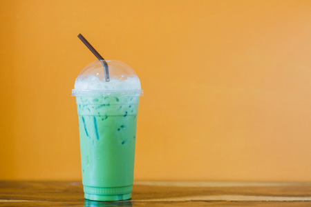 ice milk green tea on table の写真素材
