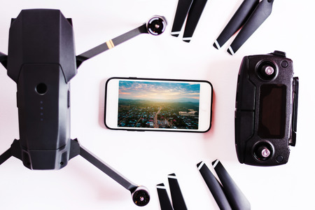Close up of spare part of Drone pro on white with mobile showing photo. One of the most portable drones in the market.の写真素材