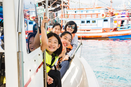 Kids are enjoying the ocean during riding on speed boatの写真素材