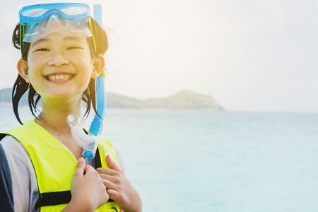portrait of an asian snorkeling girl with maskの写真素材