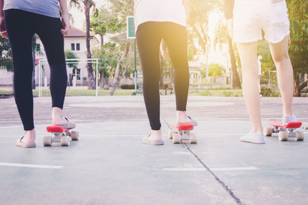 girls are ready to getting start to skateboard at yard