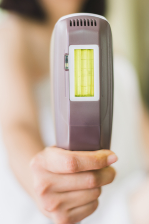 woman holding personal IPL lase epilation prepare for skin care at homeの写真素材