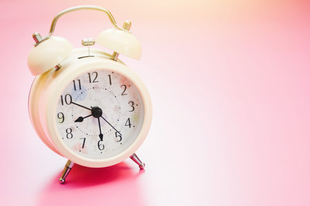 Retro alarm clock with bell on table