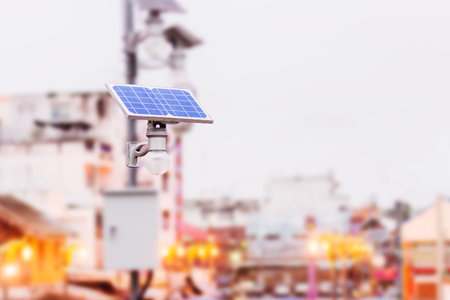 light bulb with solar panel i n big town. concept clean energy in future