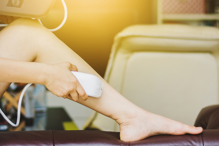 woman useing personal IPL lase epilation prepare for skin care at homeの写真素材