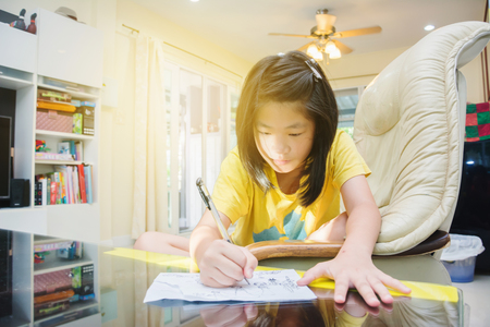 Cute Asian kids drawing cartoon at home in morningの写真素材