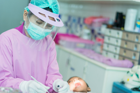 Nakhonsawan, Thailand : 2 March 2018, Dentist and Dentist assistant Checking teeth for children at sanitation.のeditorial素材