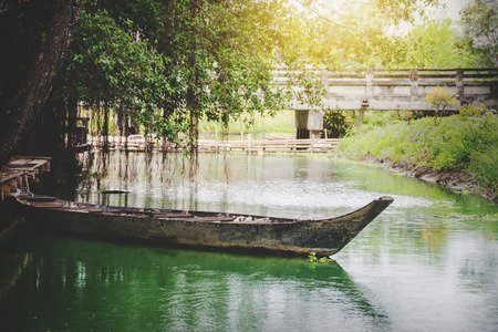 old wooden boat flooding at famous canal at countryside in Thailandの写真素材