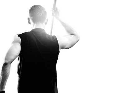 sportsman warming up and practicing javelin throw in yardの写真素材