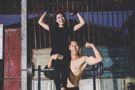 A couple enjoy exercise together in local gymの写真素材