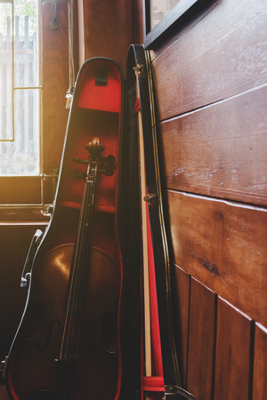 old violin in bag put on the corner of roomの写真素材