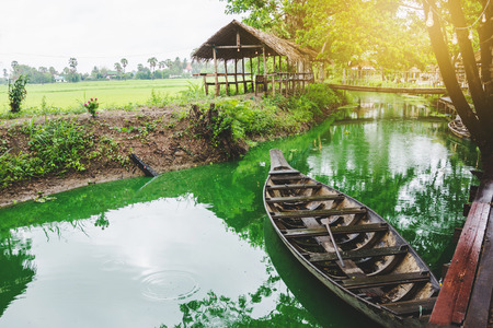 cottage and boat at famous canal at countryside in thailandの写真素材