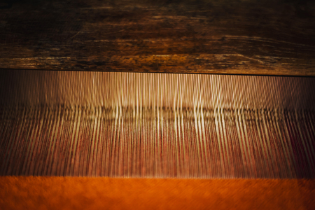 Close up of Thai Silk weaving on a traditional loom. Close up Thai silk thread. Making of thai silk. shallow depth of fieldの写真素材