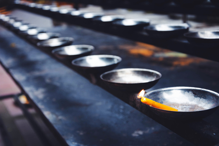 a row of Candle holder in Templeの写真素材