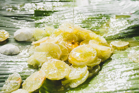 Slice lemon with honey on banana leafの写真素材