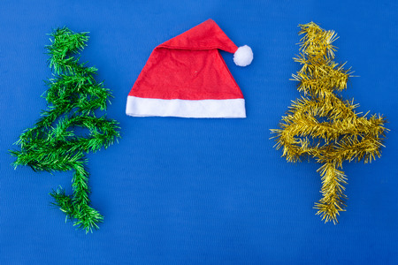Christmas background with red hat, gifts, tree decorationの写真素材