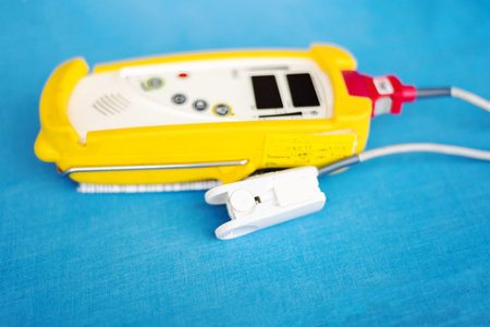 Fingertip Pulse Oximeter for oxyhemoglobin on blue background