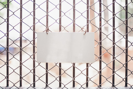 blank sign hanging in front of fence at the zooの写真素材