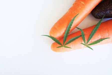 Marijuana leaf with fruit and vegetable on whiteの写真素材
