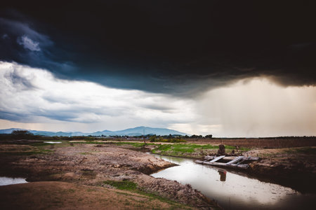 Dramatic rainy sky and dark clouds.The sky is covered with black storm clouds. Scary sky.の写真素材