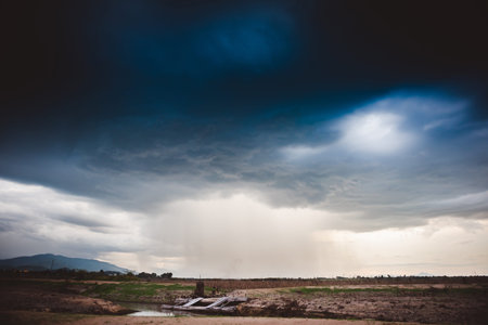 Dramatic rainy sky and dark clouds.The sky is covered with black storm clouds. Scary sky.の写真素材
