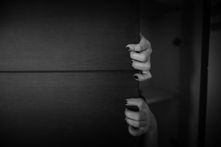 Horror shoot, hand of woman out from the closet in white toneの写真素材