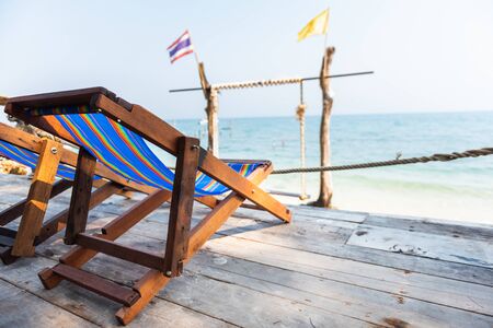 Chairs on the sandy beach near the sea. Summer holiday and vacation concept for tourismの写真素材